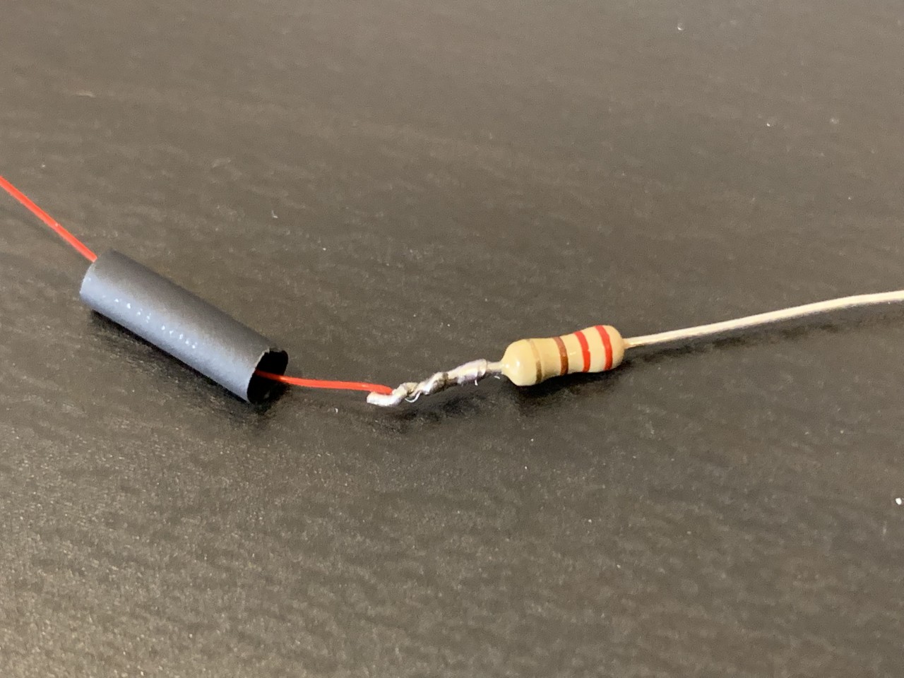 Solder wires onto the resistor, trim to size, and cover with heat shrink