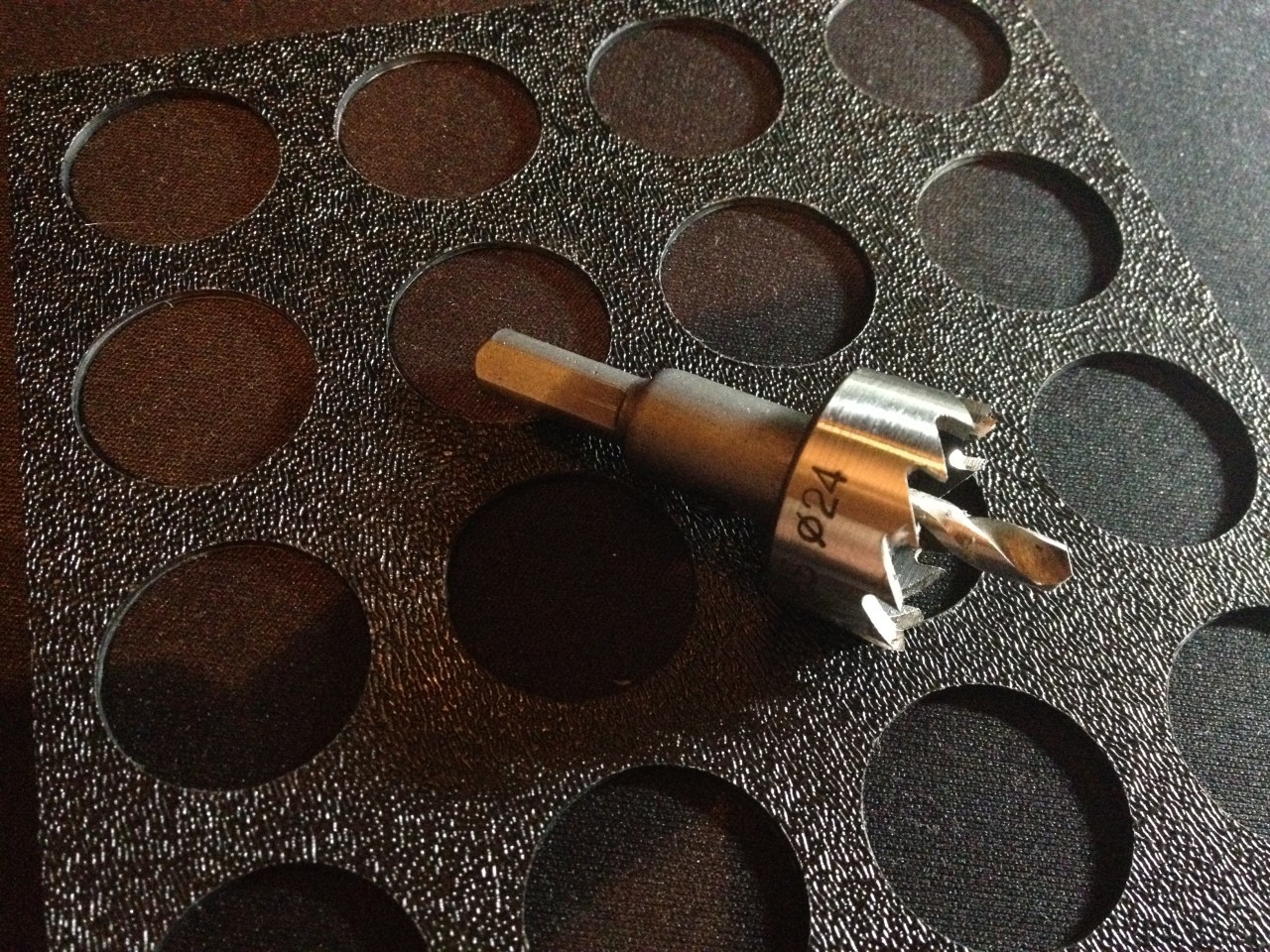 A drill bit I ordered for a few dollars on Amazon that is precisely the size of the arcade buttons.