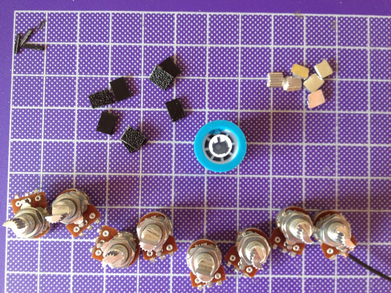 This shows how I cut off half of the shaft on the rotary potentiometers to fit the knobs. The black plastic scraps were glued with epoxy to the posts to fill out the D shape, and they fit snugly into the knobs.